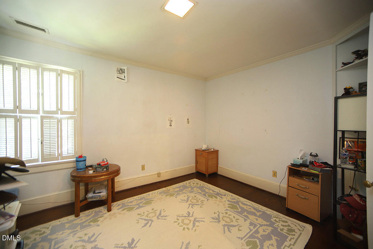 2601 York Road Raleigh, NC 27608 - Photo 13 of 24 a bedroom with furniture and a window