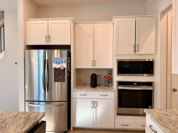 a close view of a stove a microwave and cabinets