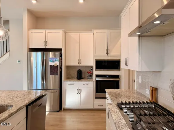 a kitchen with a sink stove and refrigerator