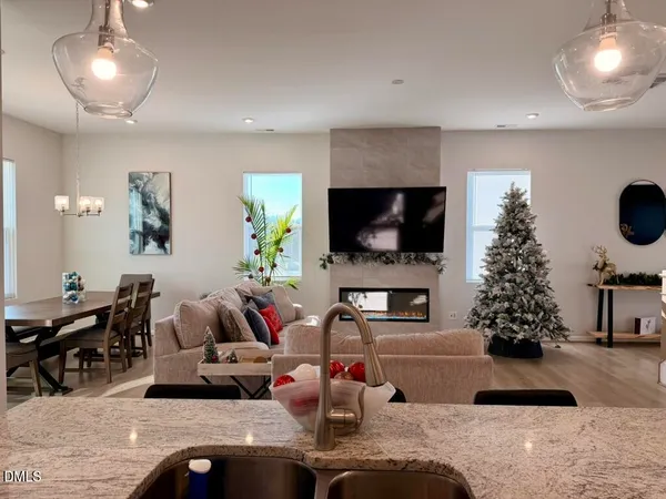 a kitchen with granite countertop a sink a counter top space appliances and cabinets