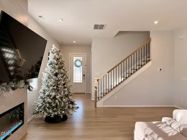 a living room with furniture kitchen view and a chandelier