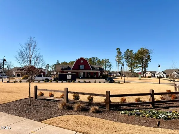 a living room with furniture and floor to ceiling windows