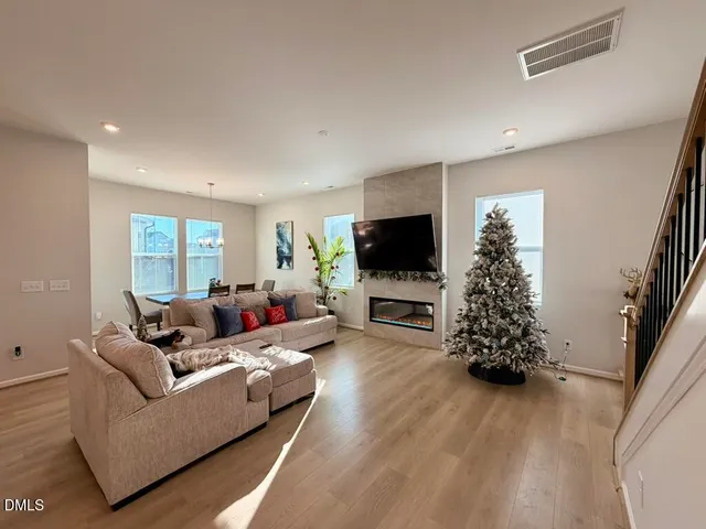a living room with furniture a fireplace and a flat screen tv