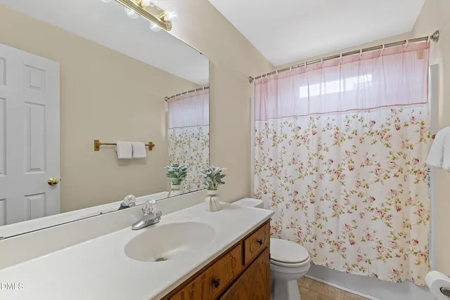 an empty room with closet and a chandelier fan