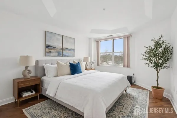 a bedroom with a bed and a potted plant