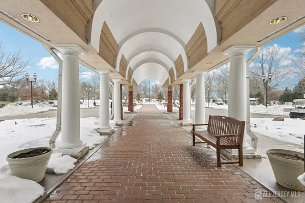a building outdoor space with patio furniture and a potted plant