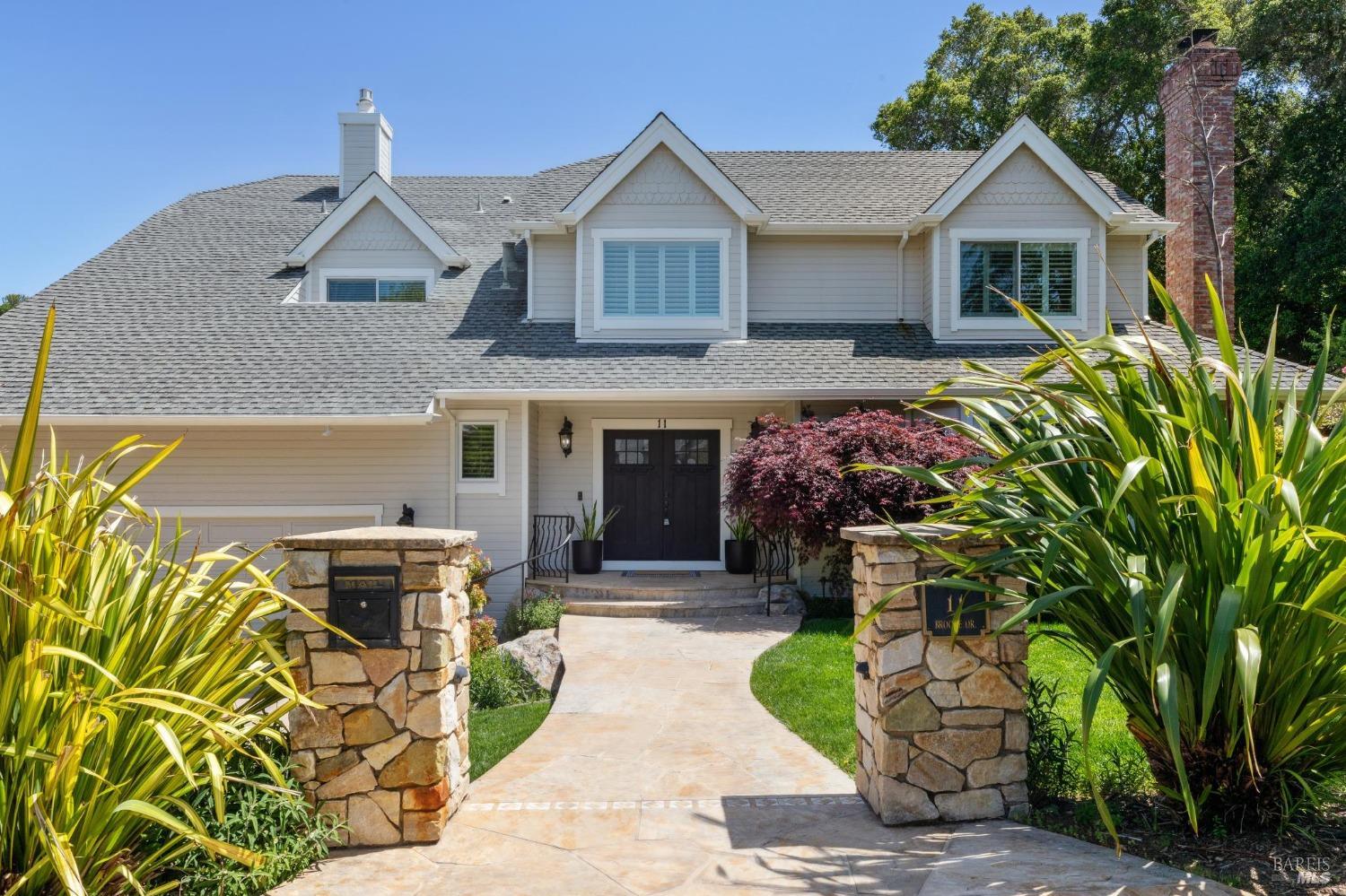a front view of a house with a garden