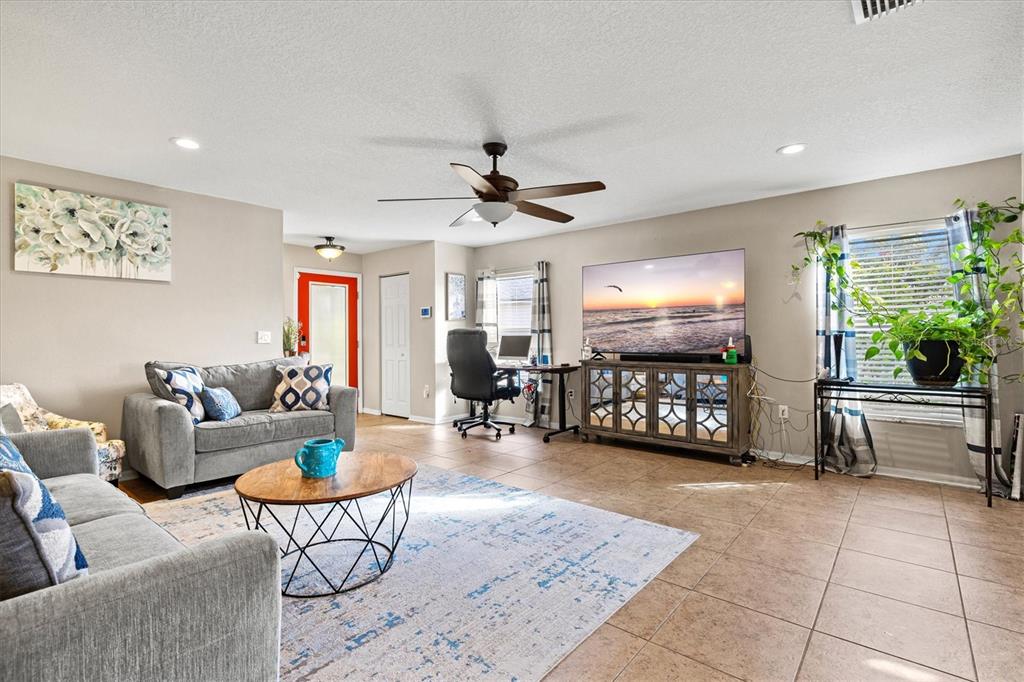 5213 Moon Shell Drive Apollo Beach, FL 33572 - Photo 12 of 69 a living room with furniture and a flat screen tv
