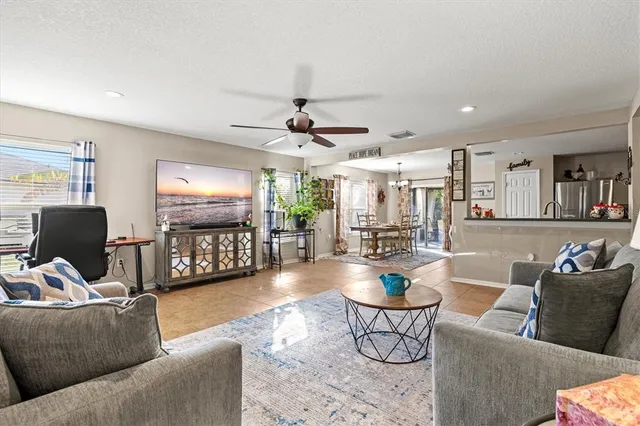 a living room with stainless steel appliances kitchen island granite countertop furniture and a kitchen view