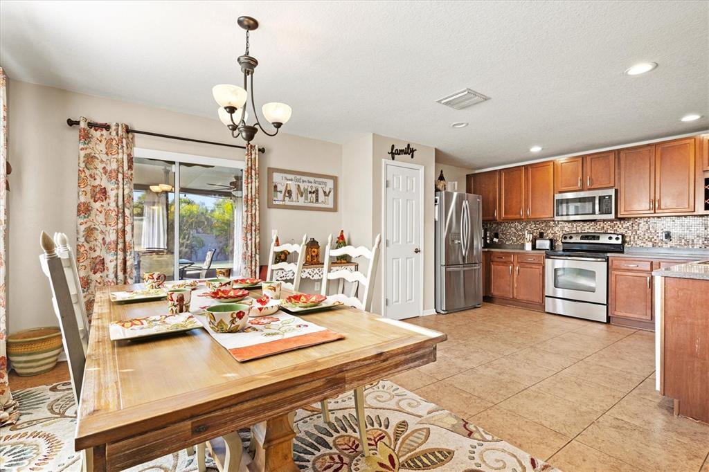 5213 Moon Shell Drive Apollo Beach, FL 33572 - Photo 14 of 69 a living room with stainless steel appliances kitchen island granite countertop furniture and a kitchen view