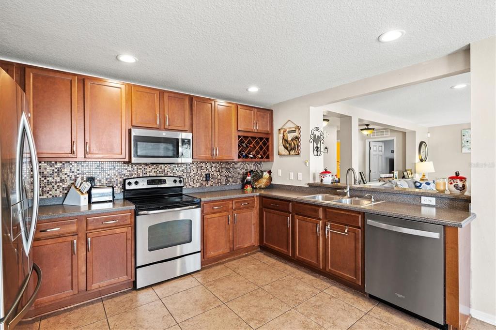 5213 Moon Shell Drive Apollo Beach, FL 33572 - Photo 17 of 69 a kitchen with sink a microwave and cabinets