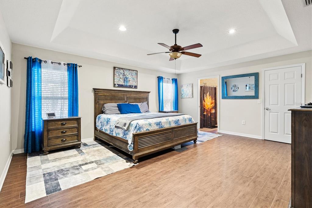 5213 Moon Shell Drive Apollo Beach, FL 33572 - Photo 19 of 69 a bedroom with a large bed and a chandelier