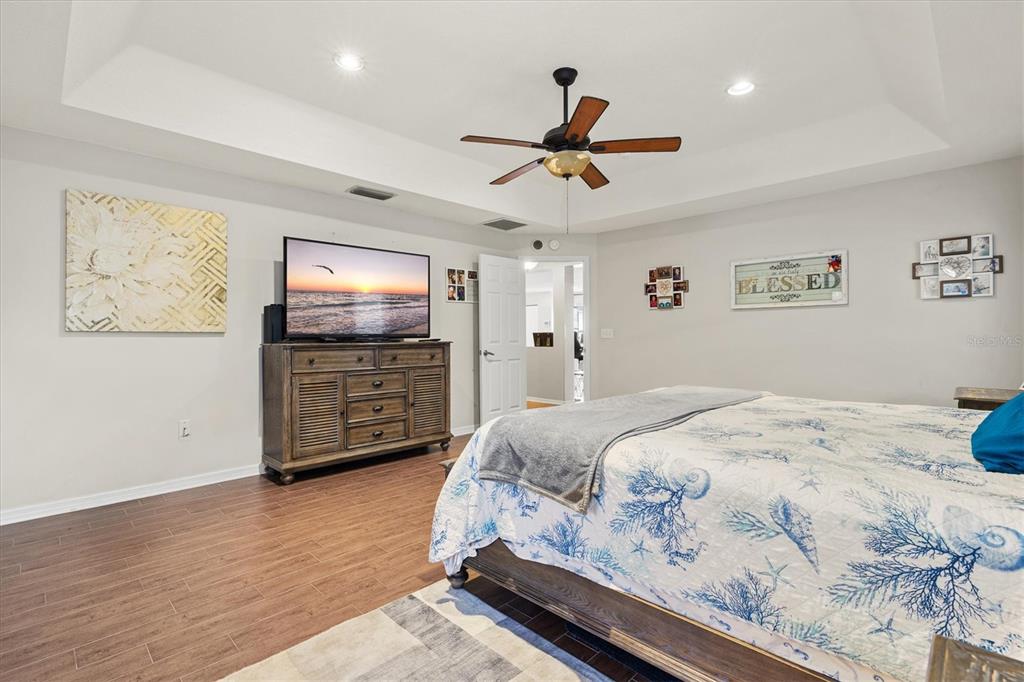 5213 Moon Shell Drive Apollo Beach, FL 33572 - Photo 20 of 69 a bedroom with a bed and a flat screen tv