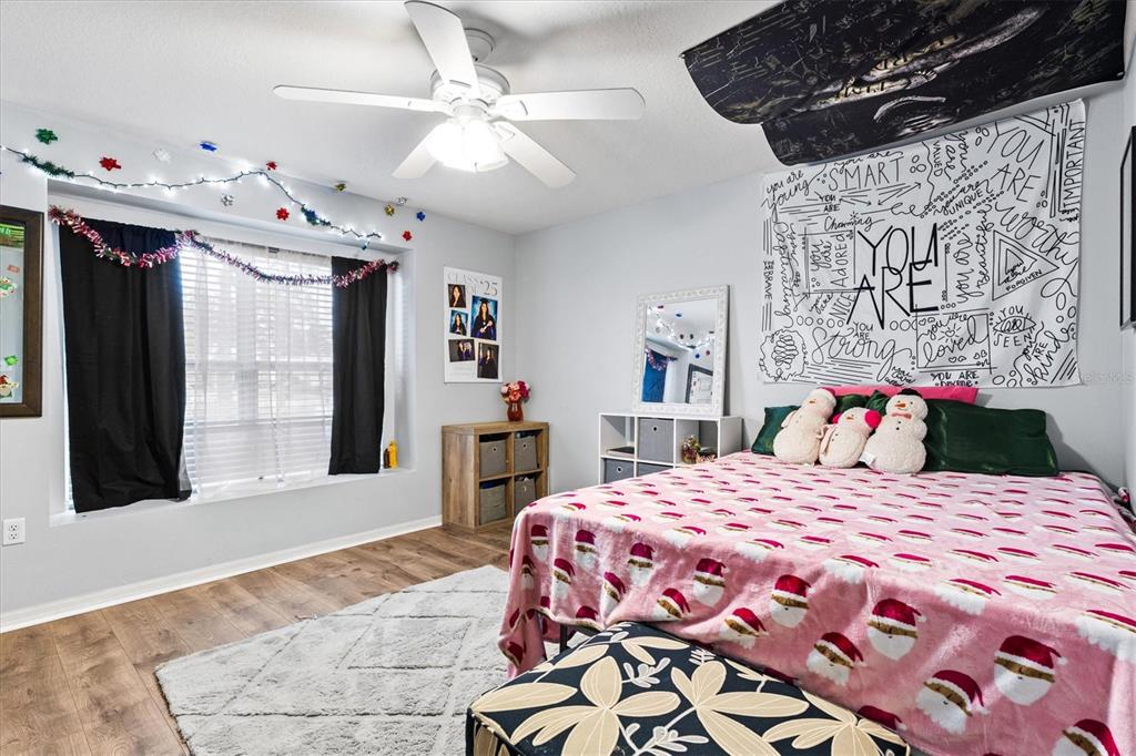 5213 Moon Shell Drive Apollo Beach, FL 33572 - Photo 22 of 69 a bedroom with a bed a dresser next to a window