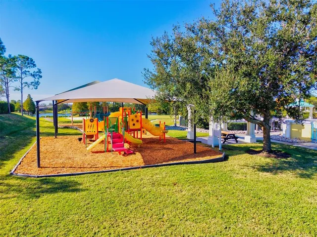 an aerial view of a house with a swimming pool and outdoor seating