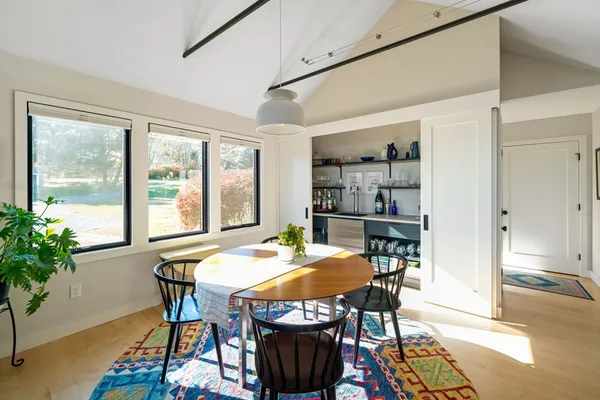 a view of a dining room with furniture window and wooden floor