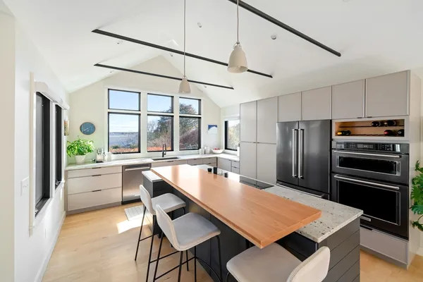 a kitchen with a table chairs refrigerator and microwave