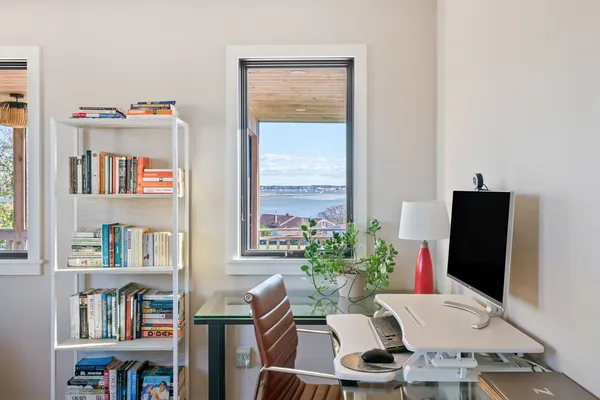 a work room with furniture potted plant and a book shelf