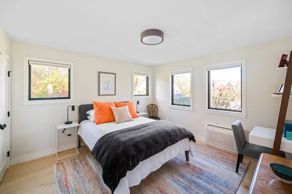 a bed room with a bed and a chair