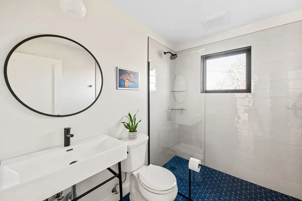 a bathroom with a sink toilet and a mirror