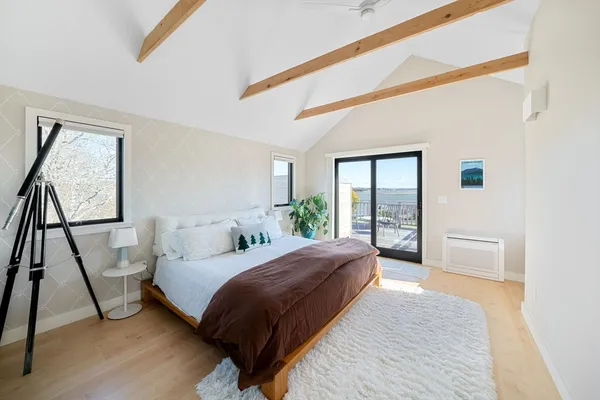 a bedroom with a large bed and a large window