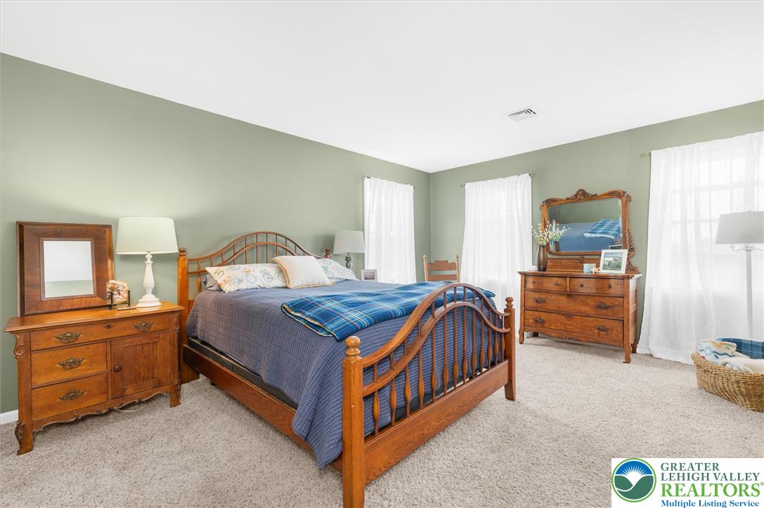 5616 Snowdrift Road Orefield, PA 18069 - Photo 14 of 36 Relax in this tranquil bedroom, featuring soft carpeting and bright windows that infuse the space with natural light.