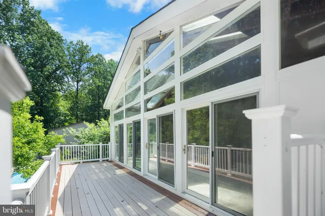 a view of a balcony with wooden floor and fence