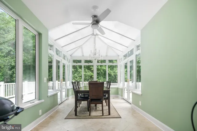 a dining room with furniture a chandelier and a rug