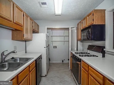 510 Berkeley Woods Drive Duluth, GA 30096 - Photo 3 of 8 a kitchen that has a sink a stove and a wooden cabinets