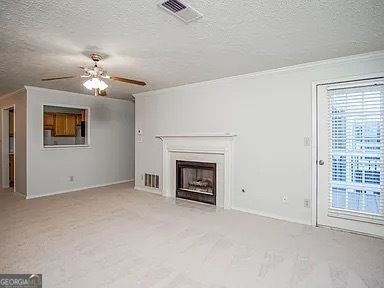 510 Berkeley Woods Drive Duluth, GA 30096 - Photo 4 of 8 a view of a livingroom with a fireplace a ceiling fan and windows
