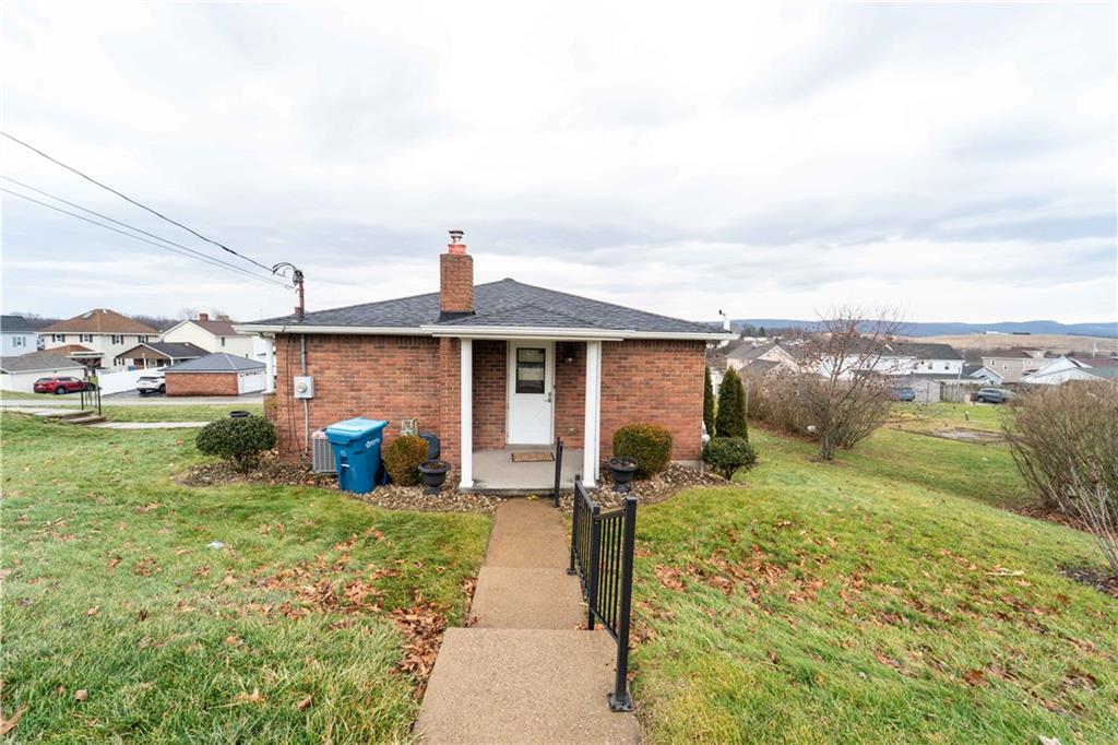 199 Spruce Street Mount Pleasant, PA 15666 - Photo 3 of 23 a front view of a house with garden