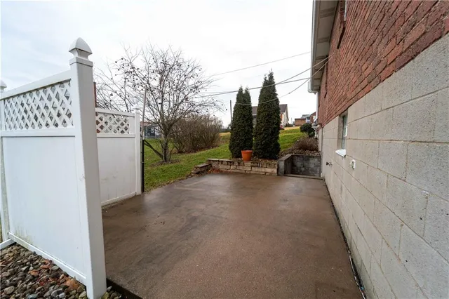 a view of a street with wooden fence