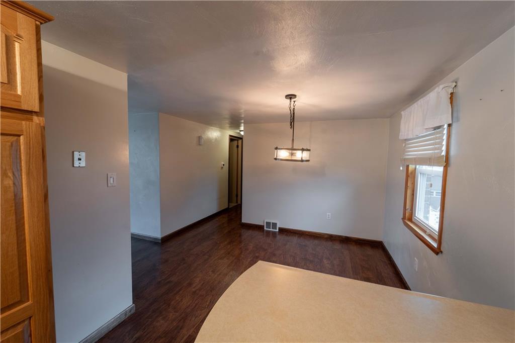 199 Spruce Street Mount Pleasant, PA 15666 - Photo 10 of 23 an empty room with wooden floor fan and windows