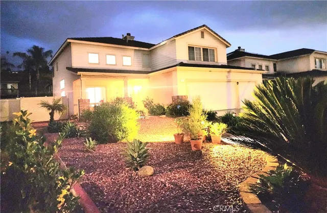 a view of a big house with wooden fence