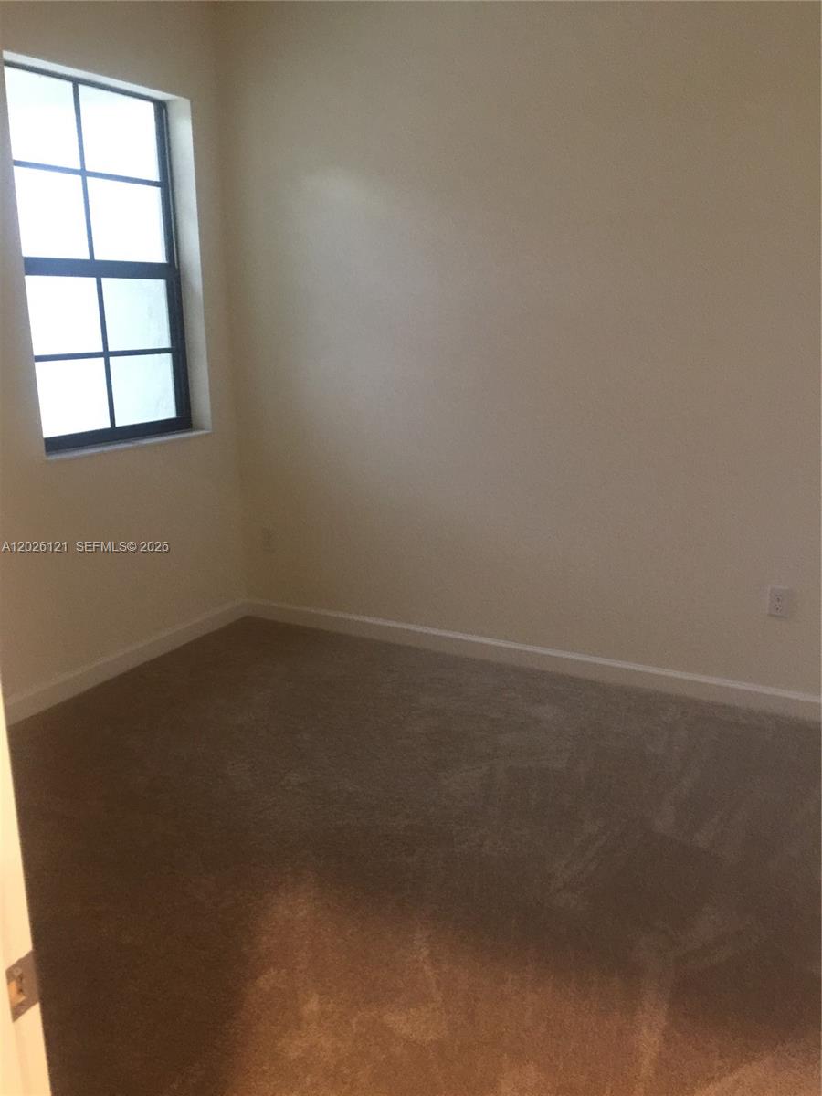 9307 West 33rd Way Hialeah, FL 33018 - Photo 13 of 23 an empty room with a window
