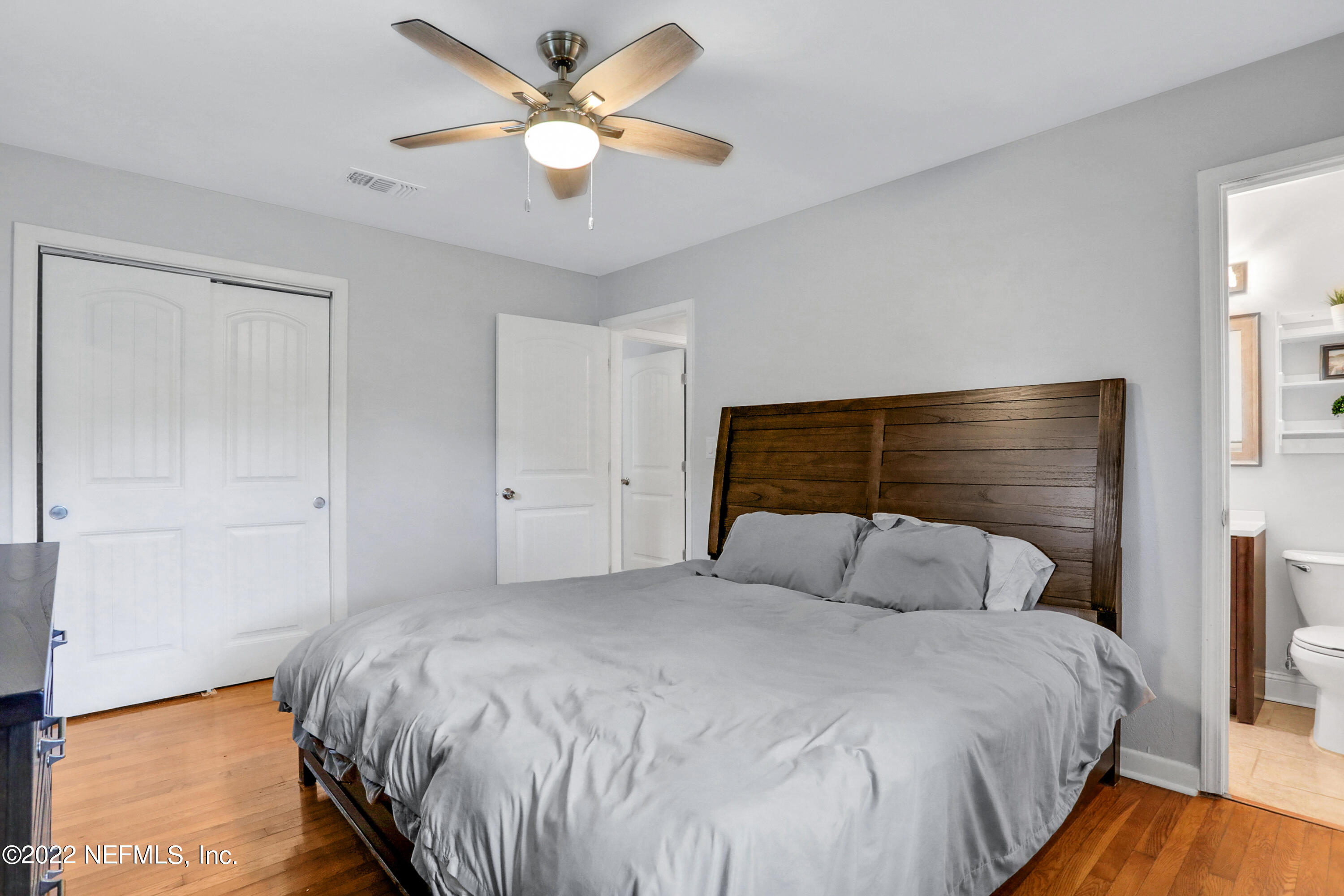 6435 Temple Road Jacksonville, FL 32217 - Photo 15 of 38 a bedroom with a bed and a chandelier
