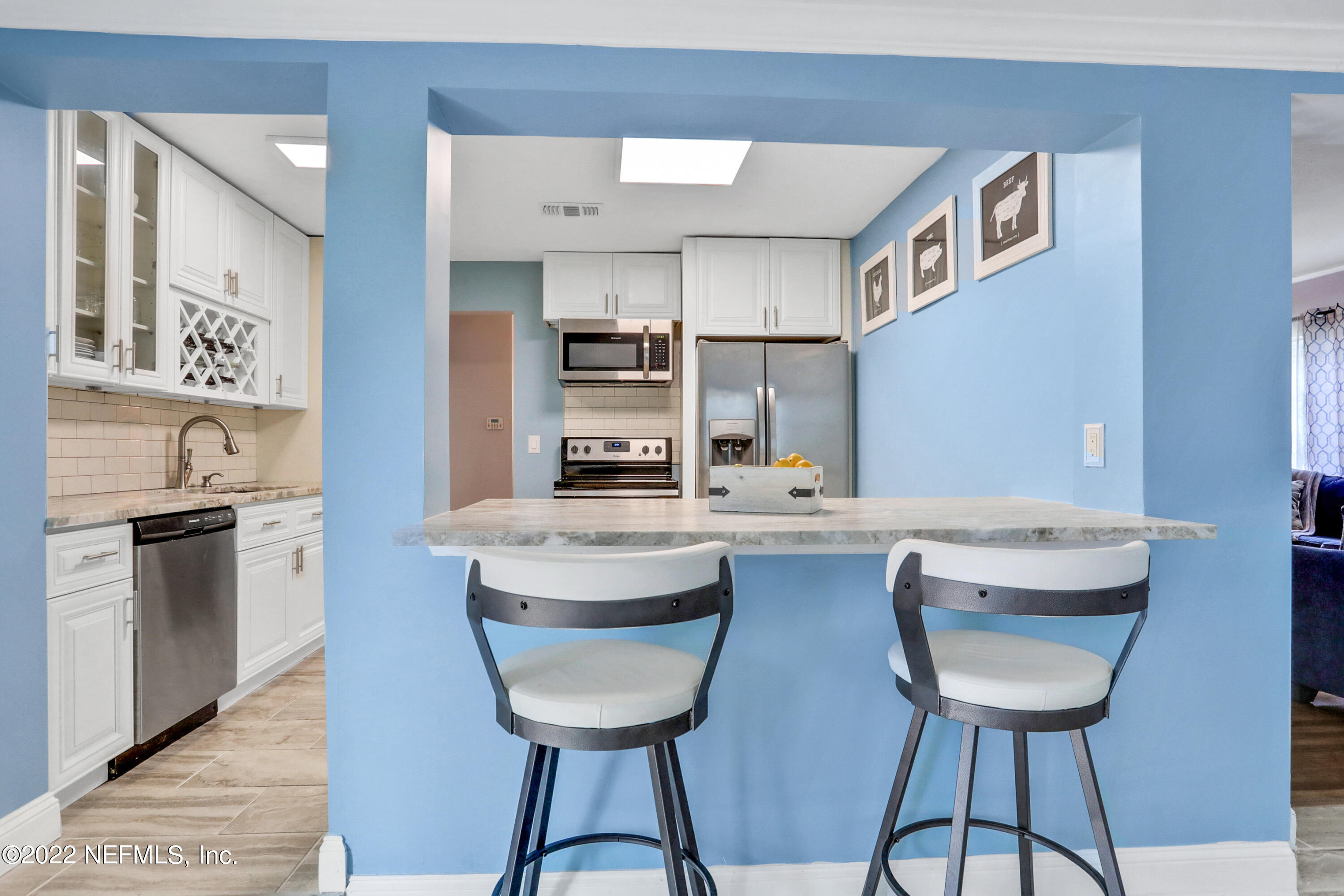 6435 Temple Road Jacksonville, FL 32217 - Photo 5 of 38 a kitchen with stainless steel appliances a table and chairs in it