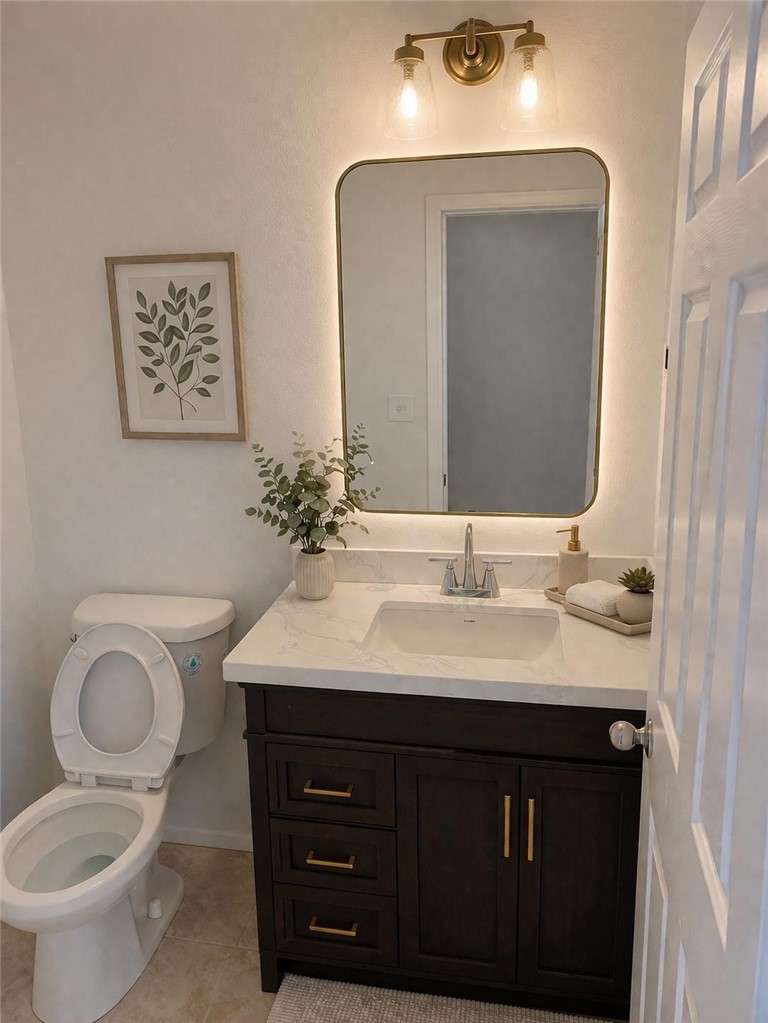 731 Raphael Circle Corona, CA 92882 - Photo 25 of 28 a bathroom with a toilet a sink and mirror