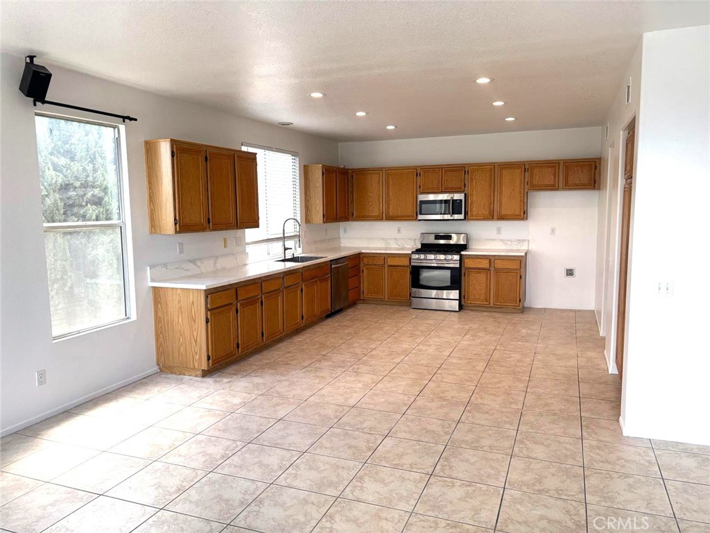 731 Raphael Circle Corona, CA 92882 - Photo 9 of 28 a kitchen with stainless steel appliances granite countertop a stove sink and cabinets