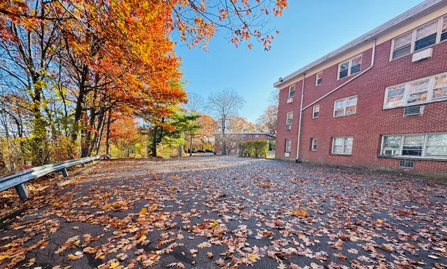 a pathway of a house with a yard