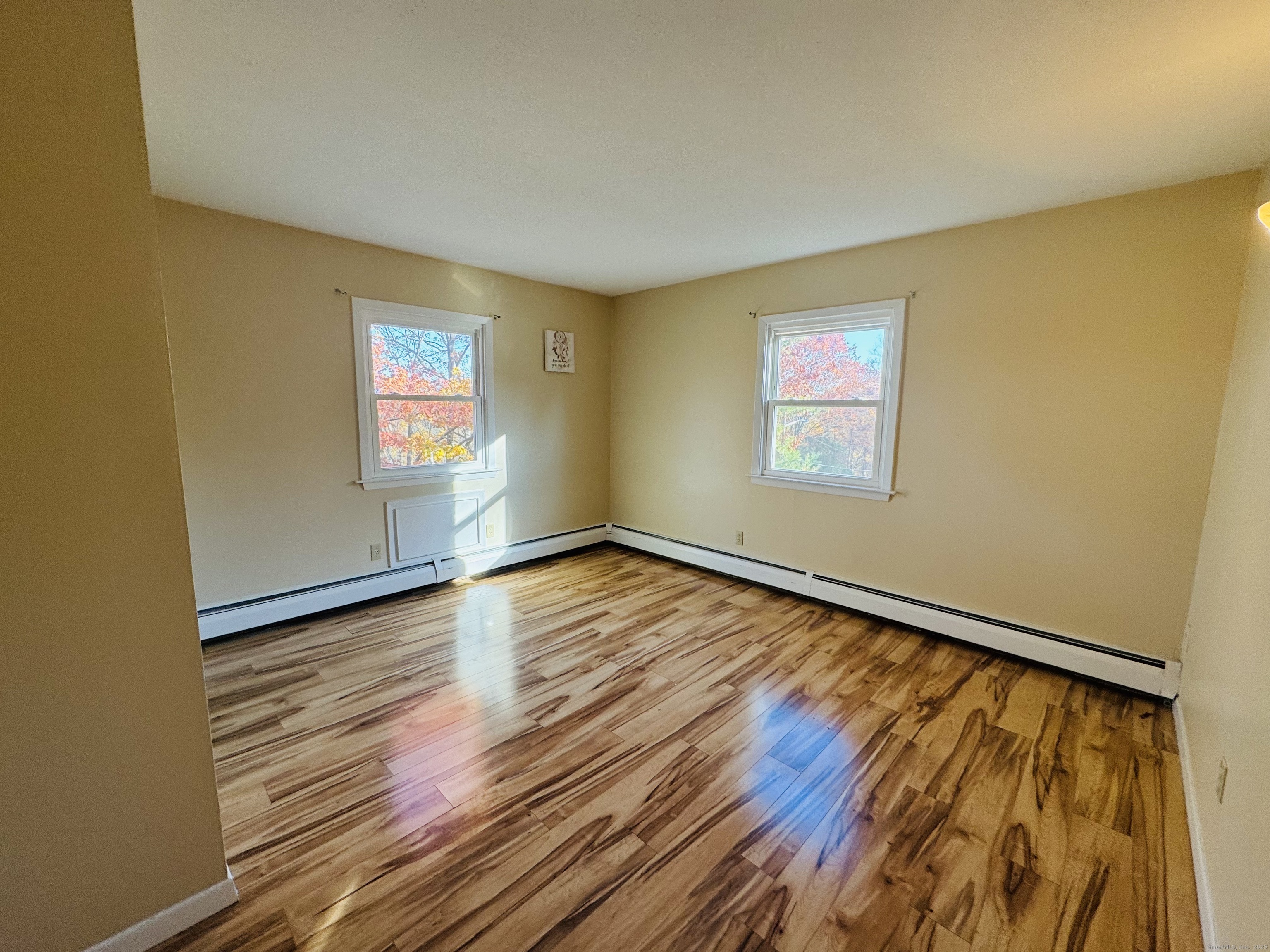 304 Pine Rock Avenue, Unit C15 Hamden, CT 06514 - Photo 2 of 14 a view of an empty room with wooden floor and a window