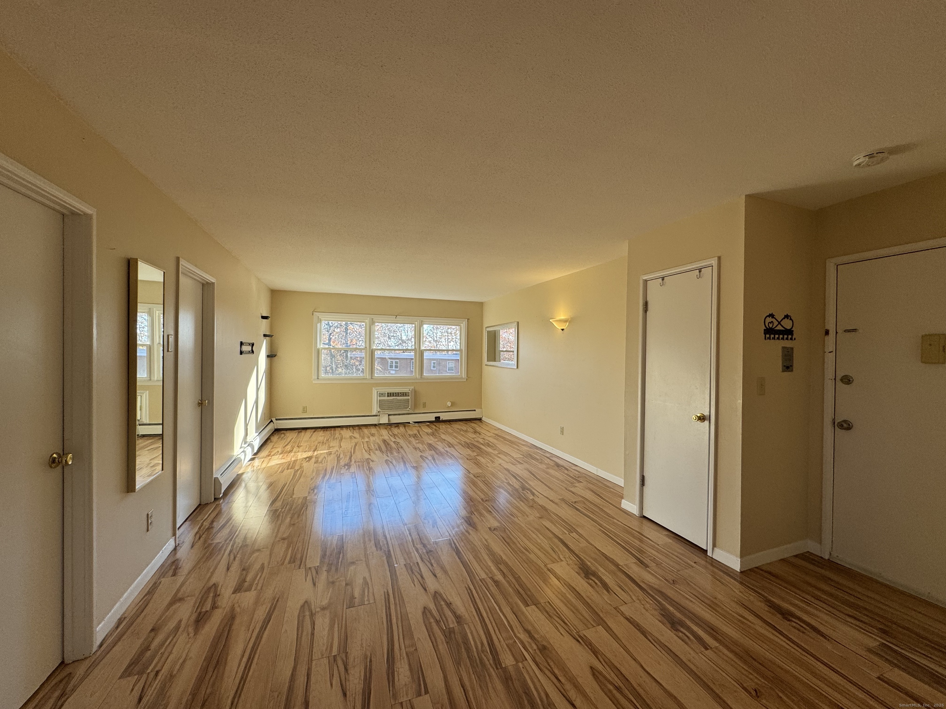 304 Pine Rock Avenue, Unit C15 Hamden, CT 06514 - Photo 6 of 14 a view of empty room with wooden floor and fan