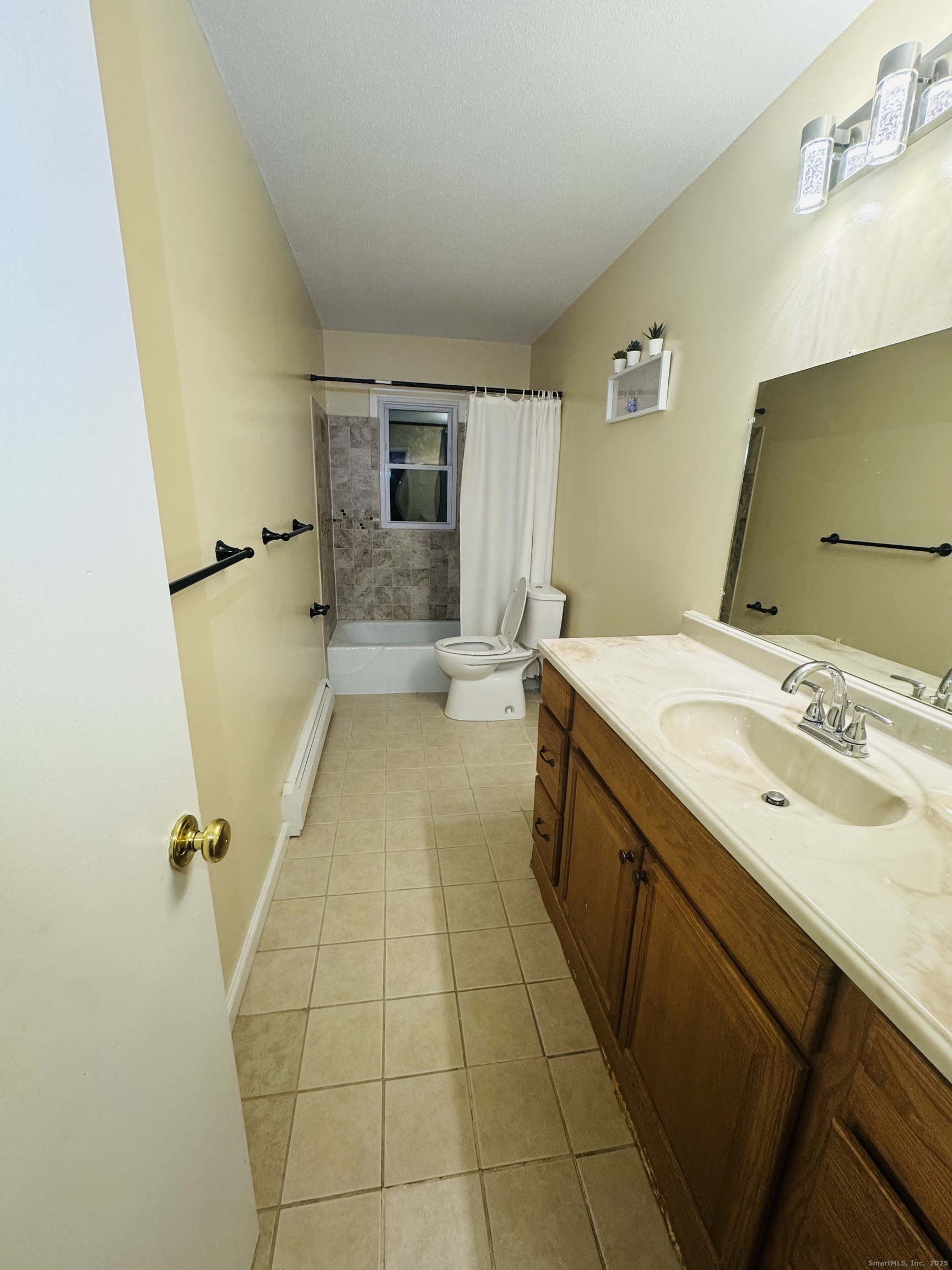 304 Pine Rock Avenue, Unit C15 Hamden, CT 06514 - Photo 7 of 14 a bathroom with a sink a toilet and mirror
