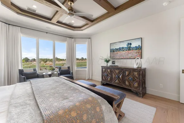 a spacious bedroom with a bed and a couch