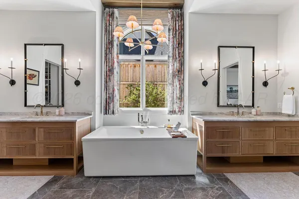 a bathroom with a granite countertop toilet sink and mirror