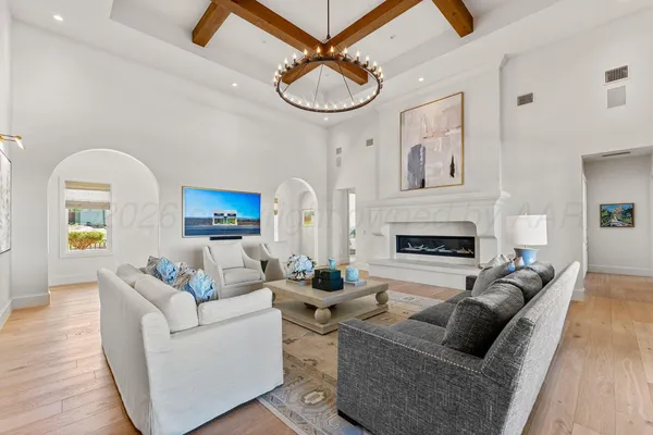 a living room with furniture a rug and a large window