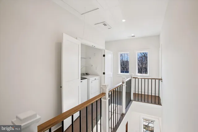 a view of a room with wooden floor and white walls
