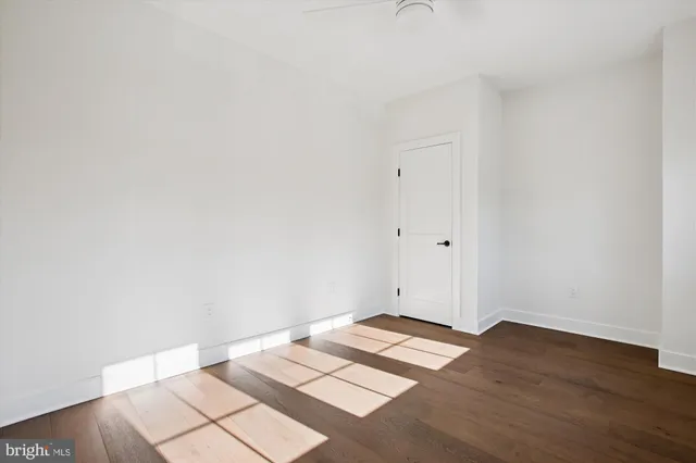 a living room with wooden floor and furniture