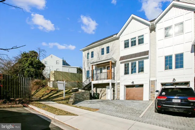 a kitchen with a refrigerator a sink and cabinets