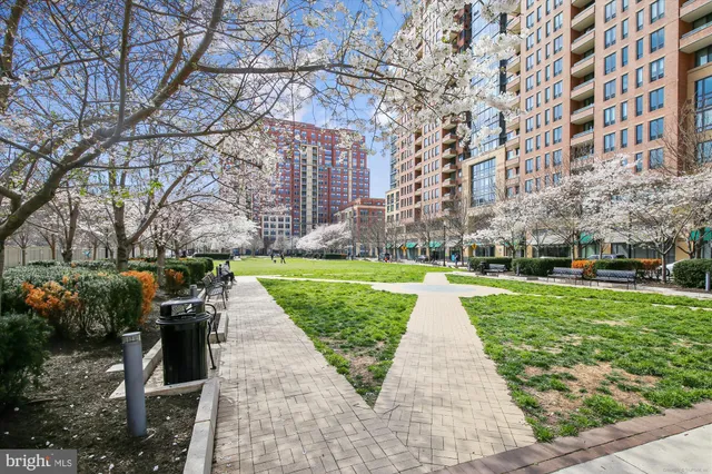 a view of swimming pool with lawn chairs and a fire pit